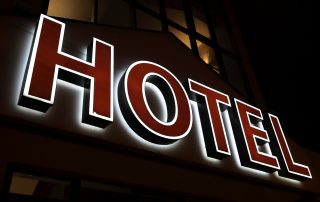 View of glowing hotel sign at night